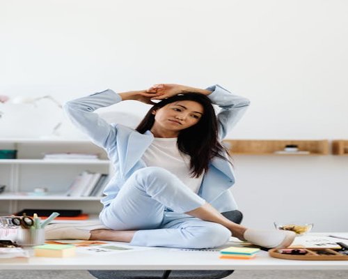 person doing light stretches by the office desk